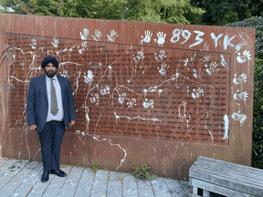 Raj Toor, a descendent of the Komagata Maaru families, stands at the vandalized memorial in Vancouver on August 22, 2021.