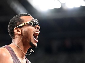 Canada's Andre De Grasse celebrates after winning the men's 200m final during the Tokyo 2020 Olympic Games.