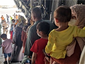 In this handout image released by the Spanish Ministry of Defence on Aug. 20, Afghan collaborators with the Spanish mission in Afghanistan and their families, arrive in Dubai prior to flying to Spain.