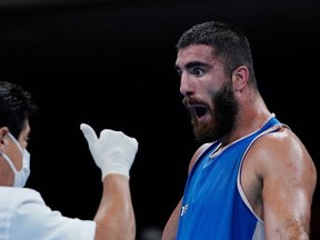 France's Mourad Aliev reacts after losing by disqualification against Britain's Frazer Clarke during their men's super heavy (over 91kg) quarter-final boxing match during the Tokyo 2020 Olympic Games.