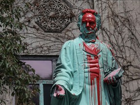 FILE: Red paint covers the defaced Ryerson University statue of Egerton Ryerson, considered an architect of Canada's residential indigenous school system, following the discovery of the remains of 215 children on the site of British Columbia's former Kamloops Indian Residential School, in Toronto, Ontario, Canada June 2, 2021.