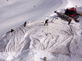 Employees of Titlis Bergbahnen cable car operator place blankets on parts of the glacier to protect it against melting on Mount Titlis near the Alpine resort of Engelberg, Switzerland July 2, 2021.
