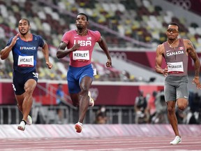 USA's Fred Kerley (C) competes with France's Jimmy Vicaut (L) and Canada's Andre De Grasse in the men's 100m semi-finals during the Tokyo 2020 Olympic Games.