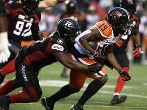 BC Lions wide receiver Dominique Rhymes (19) runs with the ball as Ottawa Redblacks defensive lineman Davon Coleman (9) tries for a tackle during first half CFL football action in Ottawa on Saturday.