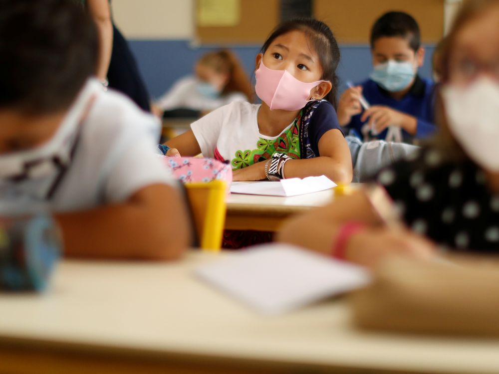 File photo/ Students wear masks in a classroom.