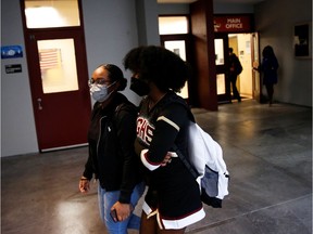 Students wearing protective masks arrive for classes on the first day of school in Miami-Dade County, amid the coronavirus disease (COVID-19) pandemic, at Barbara Goleman Senior High School, in Miami, Florida, U.S. August 23, 2021.
