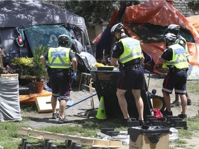 Toronto Police move on a homeless encampment in that city's Lamport Stadium Park last month.