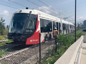 LRT workers walked alongside a slow-moving double-car train during a heat wave on Wednesday to make sure the city asset got back to the maintenance facility at Belfast Yard without any more damage. The car named Bluenose was connected at the back, a right-hand back panel at an axel removed exposing the train's mechanical guts.