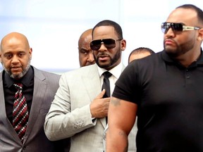 FILE PHOTO: R. Kelly walks inside the Criminal Court Building as he arrives for a hearing on eleven new counts of criminal sexual abuse,  in Chicago, Illinois, U.S., June 6, 2019.