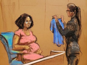 Jerhonda Pace is shown a shirt that she had worn, as singer R. Kelly attends Brooklyn's Federal District Court during the start of his trial in New York, U.S., August 18, 2021 in a courtroom sketch.