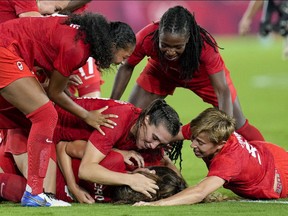 Teammates celebrate with Canada's Julia Grosso after she scored the winning goal against Sweden in the women's soccer match for the gold medal at the 2020 Summer Olympics, Friday, Aug. 6, 2021, in Yokohama, Japan.