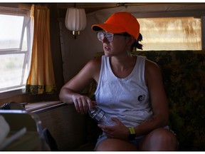 Left-wing activist Nicole Armbruster looks out the window of a trailer at her camp on a piece of land she and friends purchased in Arizona, U.S., July 10, 2021.