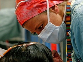 FILE: A nurse speaks with a patient at the University of Alberta Hospital in Edmonton.