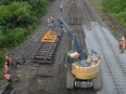 Crews replace a section of CN Rail track just east of the Edward Street overpass in Prescott on Friday afternoon.