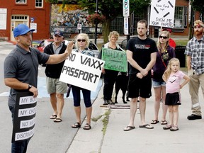 Mike Kench, left, speaks to participants at a rally opposing Ontario's planned vaccine passport system, in front of Gananoque town hall on Sunday morning.