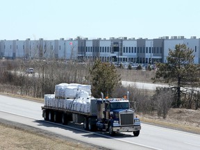 A truck rumbles along the highway by the massive Amazon warehouse on Boundary Road.