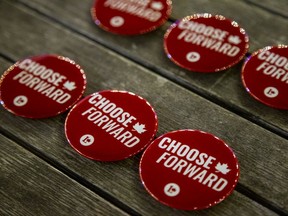 Buttons sit on the table at Mona Fortier, the Liberal candidate for the Ottawa-Vanier riding, gathering at Tavern on The Hill in Major's Hill Park on Sept. 20, 2021.