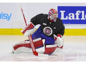 Montreal Canadiens' Carey Price does some exercises on the ice under the supervision of a member of the team's training staff at the Bell Sports Complex in Brossard on Sept. 16, 2021. Price had off-season knee surgery.