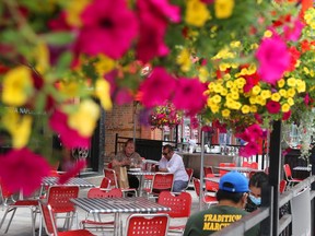 Patrons enjoy a patio in the ByWard Market in Ottawa. To survive, restaurants may have to operate very differently in future.