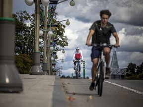 Cyclists make their way down Sussex Drive in Ottawa. Making downtown (and other) streets safe for cyclists and pedestrians is key to creating '15-minute' neighbourhoods.