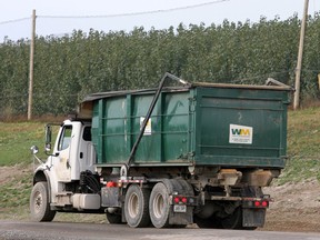 A garbage truck rolls toward the Carp Road landfill.