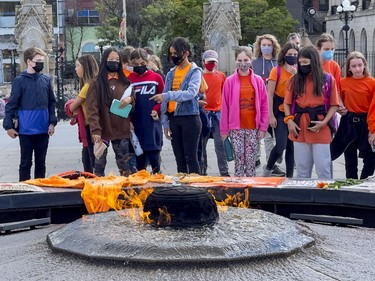 Teenagers visit the memorial to Indigenous children at the Centennial Flame on Parliament Hill on the inaugural National Day for Truth and Reconciliation. Thursday, Sep. 30, 2021