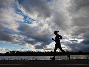 FILE: A runner makes her way along Dow's Lake under cloudy skies.