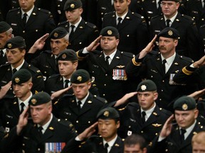 Members of Canada's military pay their respects to Sgt. Robert Short, 42, and Cpl. Robbie Beerenfenger, 29, at a memorial service in Pembroke in the fall of 2003.