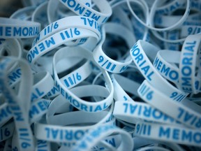 FILE: Plastic bracelets are available for those who make a donation to the September 11 Memorial and Museum on September 06, 2021 in New York City. Twenty years after al-Qaeda terrorists flew two hijacked aircraft into the North and South Towers of the World Trade Center, the 16-acre area is now a memorial to the 2,606 civilians, firefighters, and law enforcement officers who died in the towers and in the surrounding area and the 147 civilians who were aboard the airliners.