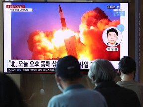 People watch a TV at the Seoul Railway Station showing a file image of a North Korean missile launch, on September 15, 2021 in Seoul, South Korea. The unidentified type of missiles were fired from central inland areas of the North on Wednesday afternoon, and the South Korean and the U.S. intelligence authorities are analyzing details for additional information, the JCS said in a release.