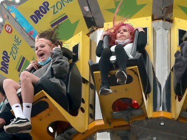 Young Hannah Jardine (right) looked positively stunned as the Drop Zone ride seemed to put her stomach in her throat as it fell from above suddenly on the midway.