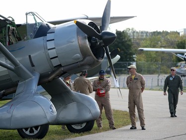 Pilots chat below a Lysander at the Gatineau Airshow on Sunday.