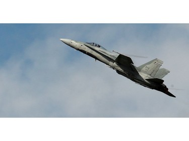 An F-18 climbs into the sky.