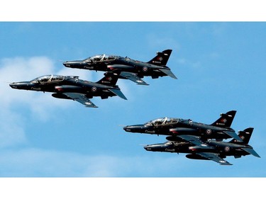A cluster of four CT-155 Hawks fly in formation.