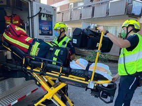 Ottawa paramedics load one of four patients who suffered smoke inhalation in a fire at at a 10-storey apartment building on Carling Avenue. One patient was in serious condition.Ottawa Paramedic Service photo
