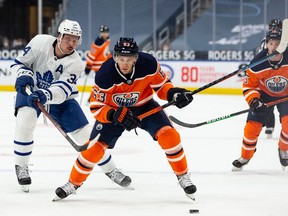 Edmonton Oilers' Tyler Ennis (63) battles Toronto Maple Leafs' Auston Matthews (34) during first period NHL action at Rogers Place in Edmonton, on Wednesday, March 3, 2021. Photo by Ian Kucerak