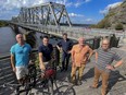 Members of the Alexandra Bridge Coalition, including left to right, Robert Pajot, Daniel Erin, Benoit Delage, Jordan Ferraro and Claude Royer are calling for the federal government to delay demolition of the current bridge and to study the possibility of maintaining it, but closing it to motorists.