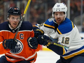 Edmonton Oilers' Connor McDavid (97) battles St. Louis Blues' Zach Sanford (12) during the second period of a NHL hockey game at Rogers Place in Edmonton, on Wednesday, Nov. 6, 2019.