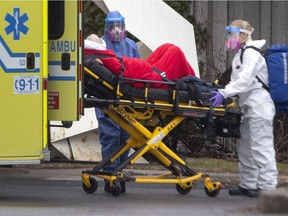 Urgences Santé paramedics transfer a senior from the Centre d'hebergement de LaSalle as the city deals the with coronavirus pandemic in Montreal, on Monday, April 13, 2020.