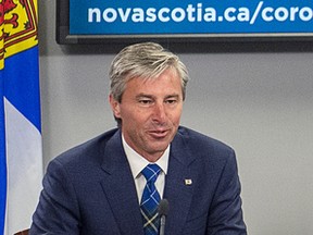 Premier-designate Tim Houston attends his first COVID-19 briefing with Dr. Robert Strang, chief medical officer of health, after the Progressive Conservatives won last week's provincial election, in Halifax on Monday, Aug. 23, 2021.