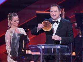 Host Norm Macdonald holds a pancake during a bit making fun of the swag bags at the Canadian Screen Awards in Toronto on Sunday, March 13, 2016. Macdonald has died after a private battle with cancer, says his management agency. He was 61.
