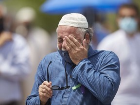 A man wipes away a tear during the funeral service for the four victims of a deadly vehicle attack in London, Ont., on Saturday, June 12, 2021. Talat Afzaal, 74, her son Salman Afzaal, 46, his wife Madiha Salman, 44, and their 15-year-old daughter Yumna Salman all died last Sunday night while out for a walk after a man in a truck drove them down in what police have called a premeditated attack because they were Muslim.