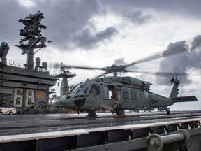 An MH-60S Sea Hawk helicopter conducts flight control checks on the flight deck of the U.S. Navy aircraft carrier USS Nimitz in the Indian Ocean, Nov., 2020.