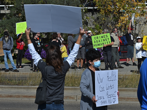 Demonstrators gather Monday outside Edmonton's Royal Alexandra Hospital in a protest organized by the Canadian Frontline Nurses.