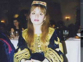 A woman poses in traditional Afghan attire, in U.S., 1997, in this picture obtained from social media.