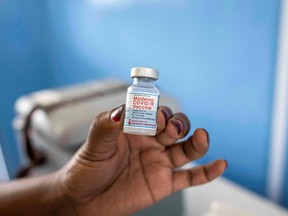 FILE: A nurse holds a vial of Moderna vaccine.
