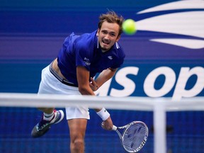 Russia's Daniil Medvedev hits a return to Canada's Felix Auger-Aliassime during their 2021 US Open Tennis tournament men's semifinal match at the USTA Billie Jean King National Tennis Center in New York, on September 10, 2021.