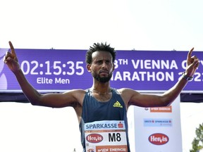 Ethiopia's Derara Hurisa celebrates winning the 38th edition of the Vienna City Marathon in Vienna, Austria, on September 12, 2021. He was later disqualified for improper footwear.
