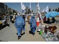 Burqa-clad women visit a temporary second-hand market in Kabul's  Chaman-e-Huzuri neighbourhood on Sept. 16.