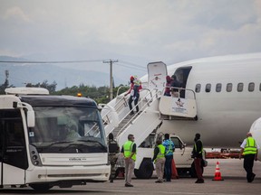Expelled migrants arrive on September 19, 2021 at the airport in Port au Prince on September 19, 2021. - After weeks on the road, traversing mountains and jungles, risking assault and drowning, thousands of Haitian migrants hoping to reach the United States, instead found themselves stranded in Mexico and returned to Haiti.